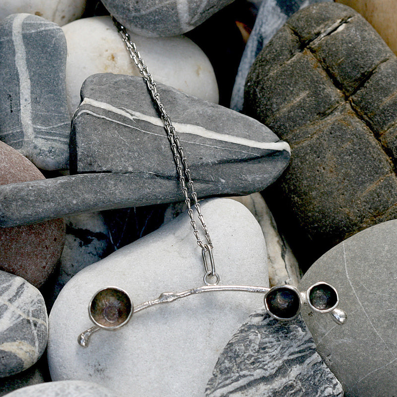 Handmade in Sterling silver my acorn necklace is strung on a 33 inch silver barleycorn chain. The pendant is 2 inches across and has three or four stylised acorn cups that can be gold plated, oxidised or polished silver.