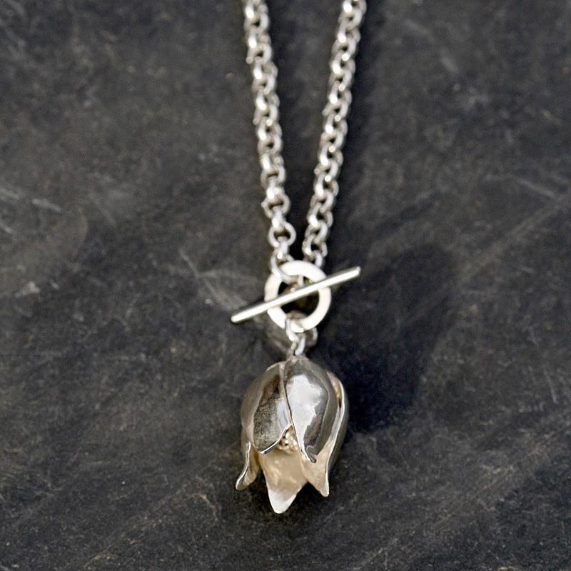 A hallmarked Sterling silver single fritillaria lily necklace on an 17 inch Sterling silver belcher chain. Statement flower jewellery by Sally Wilcox UK.