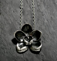 My very sculptural Sterling silver large orchid flower is made in three pieces before being assembled, burnished and carefully oxidised to produce a beautifully balanced statement necklace.