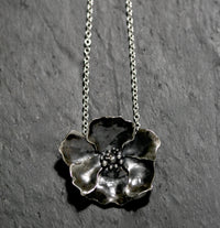 Large solid Sterling silver poppy flower necklace in 18 inch heavy 100 flat oval chain with a handmade hook catch. It measures 5.5 by 5cm and weighs 39 grams. Statement floral jewellery, handmade in England and hallmarked in London.