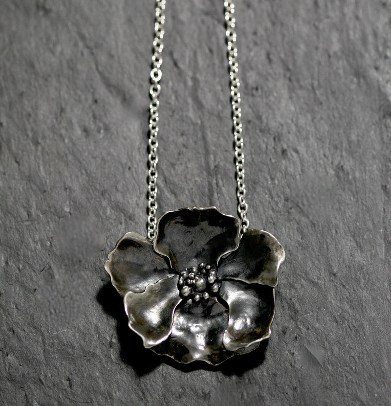 Large solid Sterling silver poppy flower necklace in 18 inch heavy 100 flat oval chain with a handmade hook catch. It measures 5.5 by 5cm and weighs 39 grams. Statement floral jewellery, handmade in England and hallmarked in London.