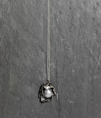 Hand carved Sterling silver rose necklace with two layers of individually shaped rose petals, gently oxidised before a baroque pearl is carefully set and re-polished. On an 18 inch Silver trace chain with a handmade hook catch.